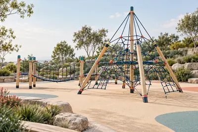 AI concept visual: an outdoor rope play structure, large geometric rope climbing pyramid with tensioned navy ropes between slim timber masts, connected low rope bridge, pale sand-coloured rubber.