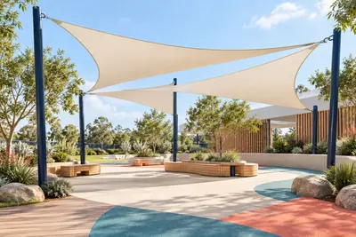 AI concept visual: architectural shade structures for a playground: three overlapping cream tensile shade sails on slim navy poles, light timber benches below, bright contemporary landscaped.